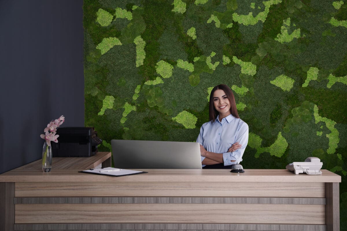 Portrait of receptionist at desk in lobby