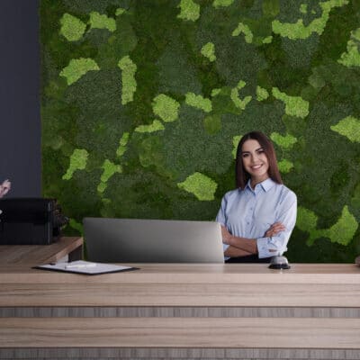 Portrait of receptionist at desk in lobby