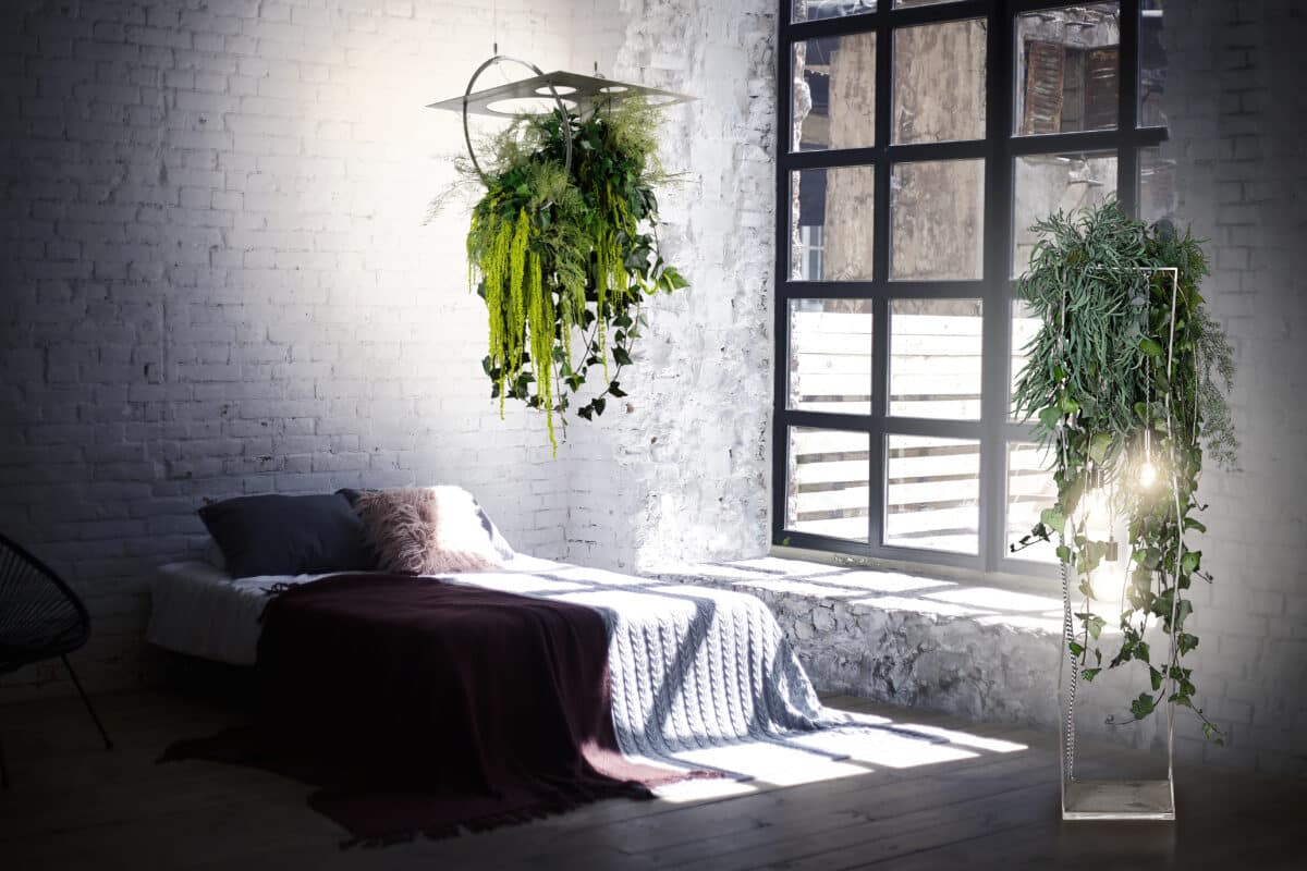 Loft bedroom interior with big windows and light walls