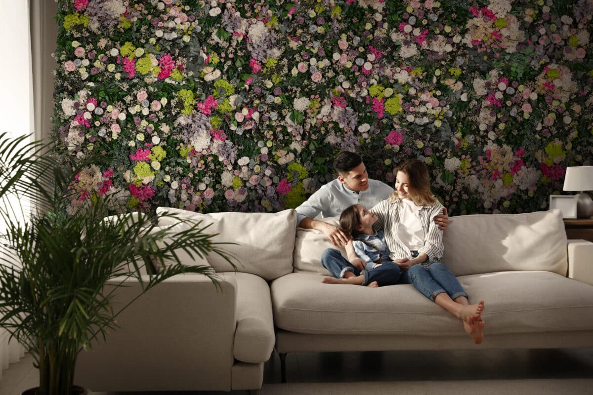 Family with little daughter resting on sofa in living room